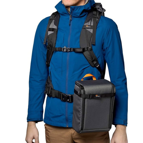 Photo backpack worn on torso with black padded camera pouch and front chest straps