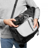Black photo backpack with open top zip compartment and light-gray interior insert