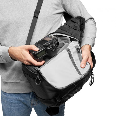 Black photo backpack with open top zip compartment and light-gray interior insert