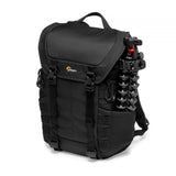 Black camera backpack with side panel storage and tripod legs secured on outer straps