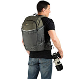 Olive and gray photo backpack, side view with shoulder straps and camera-ready access