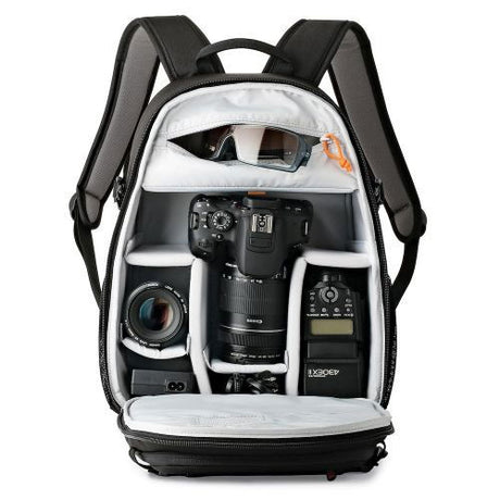 Black photo backpack interior with camera gear, lens, and multiple padded slots