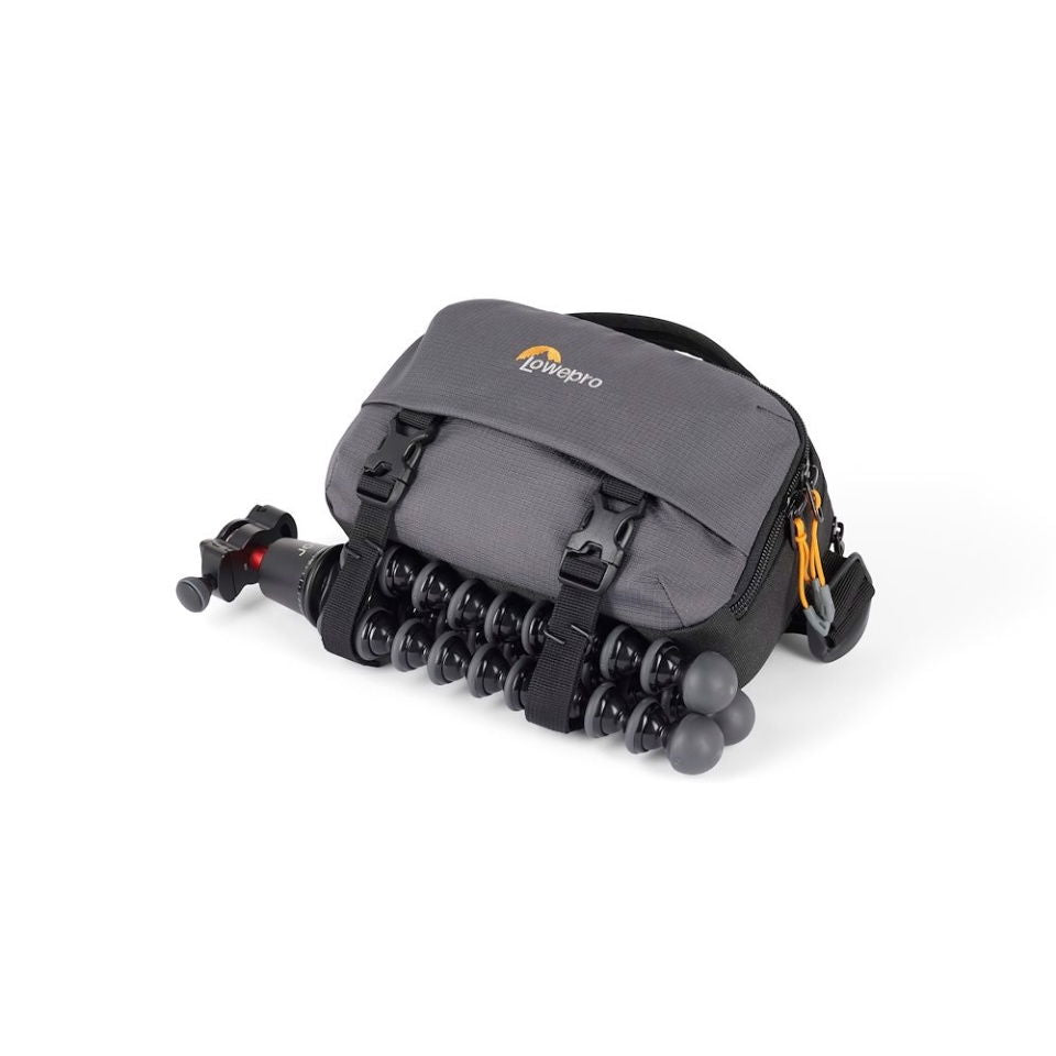 Gray camera bag with tripod legs attached to the front panel