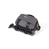 Gray camera bag with tripod legs attached to the front panel