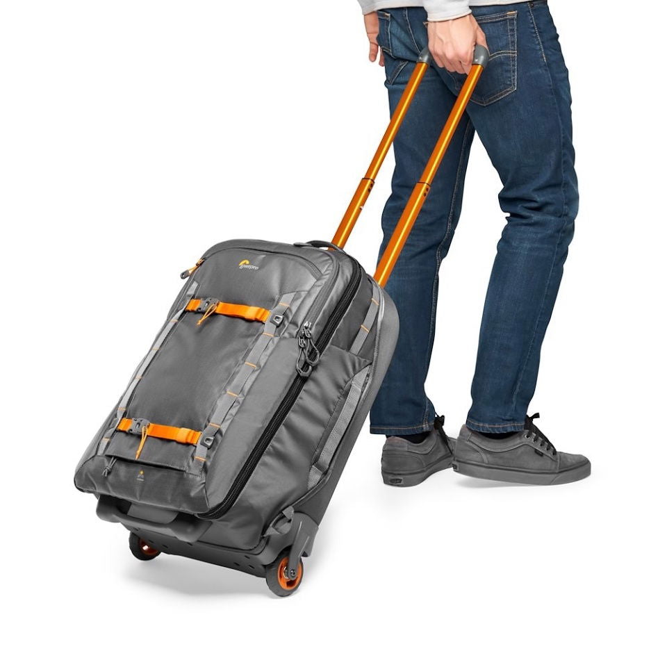 Gray wheeled photo/video trolley with orange trim, shown pulled by telescoping handle