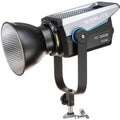 Bi-color LED studio light with front reflector and yoke mount, black/silver
