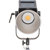 Bi-color LED studio light head with circular reflector and warm LED core, front view