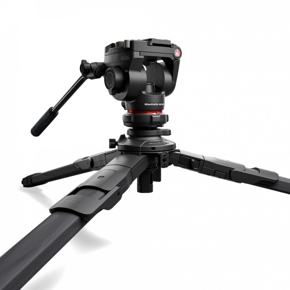 Fluid video head mounted on three-section tripod legs, close-up view