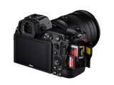 Mirrorless camera with 24-70mm lens, rear/side view, tilting LCD visible