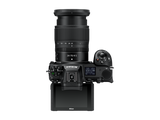 Mirrorless camera with 24-70mm f/4 lens, lens pointing up, back LCD visible