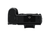 Mirrorless camera bottom view showing tripod mount and battery door