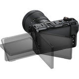 Mirrorless camera body with tilting LCD screen open and mounted lens, black