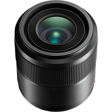 Black 30mm macro lens angled front, showing circular glass and ribbed barrel