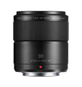 Black 30mm macro camera lens, ribbed focus ring and front glass