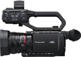 Side view camcorder with control panel buttons, input dials, and zoom lens ring