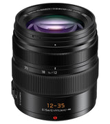 Front view of black 12–35mm lens showing glass element and focus markings