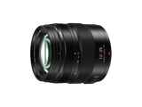Angled view of black 12-35mm f/2.8 lens with textured zoom rings and front element