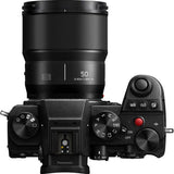 Black L-mount 50mm f/1.8 lens mounted on camera body, controls visible
