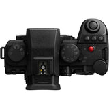Black mirrorless camera top view with mode dial and prominent red record button