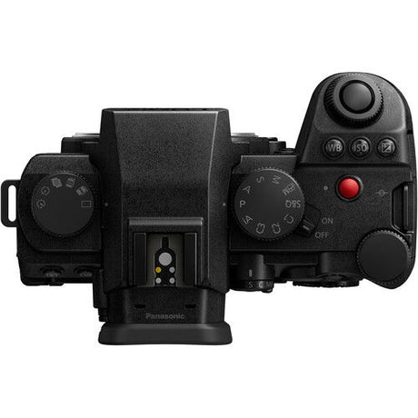 Black mirrorless camera top view with mode dial and control buttons