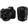 Mirrorless camera with 20–60mm zoom and 50mm lens, black body
