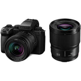 Mirrorless camera with 20–60mm zoom and 50mm lens, black body