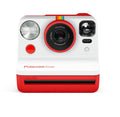Red instant camera front view with lens, flash, and autofocus ring