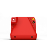 Red instant camera back view with ports and yellow power button