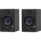 Black studio monitor speaker with blue-lit controls and front tweeter/woofer grilles.