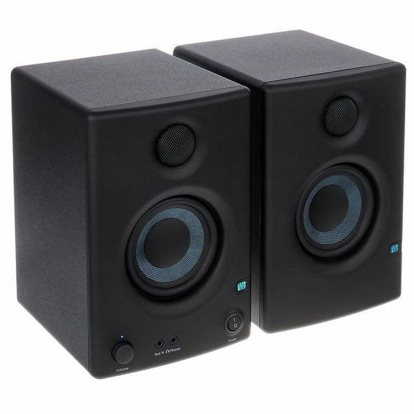 Black multimedia monitor speakers, angled view of left and right boxes with blue cones