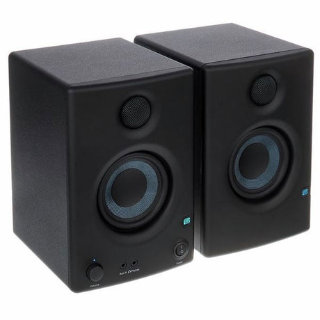Black multimedia monitor speakers, angled view of left and right boxes with blue cones