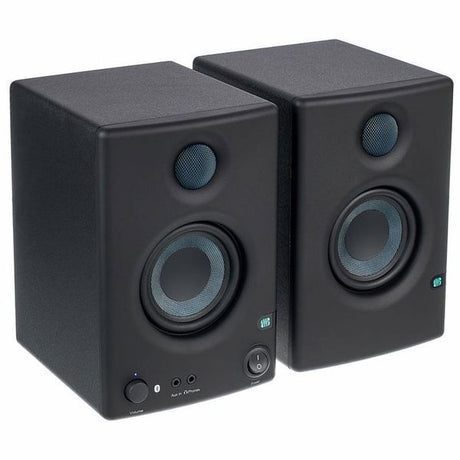 Front view of two dark studio monitors showing tweeters and woofers