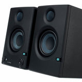 Angled view of two dark studio speakers with tweeters and bass drivers
