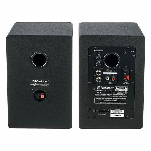 Back panel of two black studio speakers with input terminals and power labels