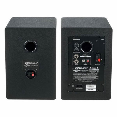 Back panel of two black studio speakers with input terminals and power labels