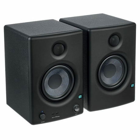 Studio monitor speaker pair in black, angled view showing tweeters and woofers