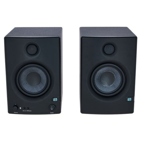 Black studio monitor pair, close-up front with tweeter and woofer cones