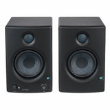 Black studio monitor speakers front view, volume and input controls on lower panel