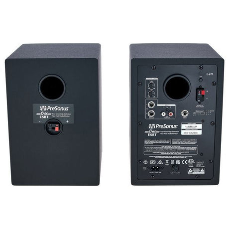 Back panel of black studio monitor speakers with input ports and controls