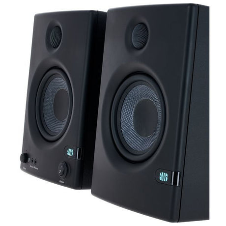 Close-up angled front of black studio monitor speakers, tweeter and woofer