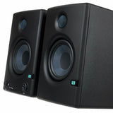 Angled close view of black studio monitor speakers, tweeter and woofer detail