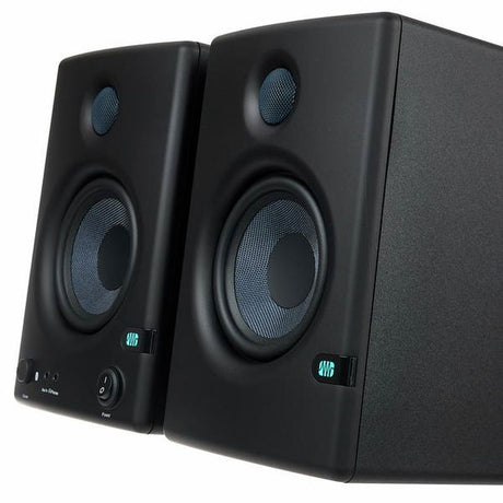 Angled close view of black studio monitor speakers, tweeter and woofer detail