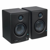 Studio monitor speakers in angled view, front tweeter and woofer drivers visible