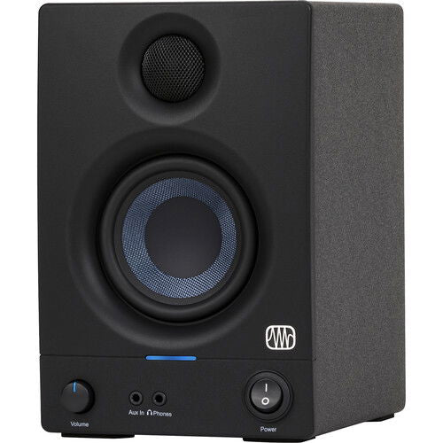 Close front angle of black studio monitor speaker showing tweeter, woofer, and power controls