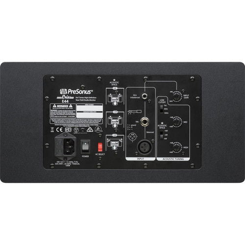 Studio monitor speaker rear panel with ports and input controls, dark cabinet