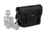 Black camera messenger bag with flap, buckles, and padded shoulder strap