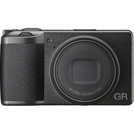 Black compact camera front with lens cap-like cover and GR logo on right side