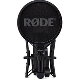 Black studio condenser microphone with circular pop filter and stand mount