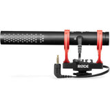 Black shotgun microphone with red shock mount, visible output connector and cylindrical body