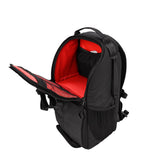 Black photo backpack opened to show red padded interior and side zipper compartment